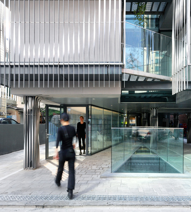 View of Entry Plaza: The micro-auditorium, entry lobby, and sky-wells punctuate the public open ground plane.